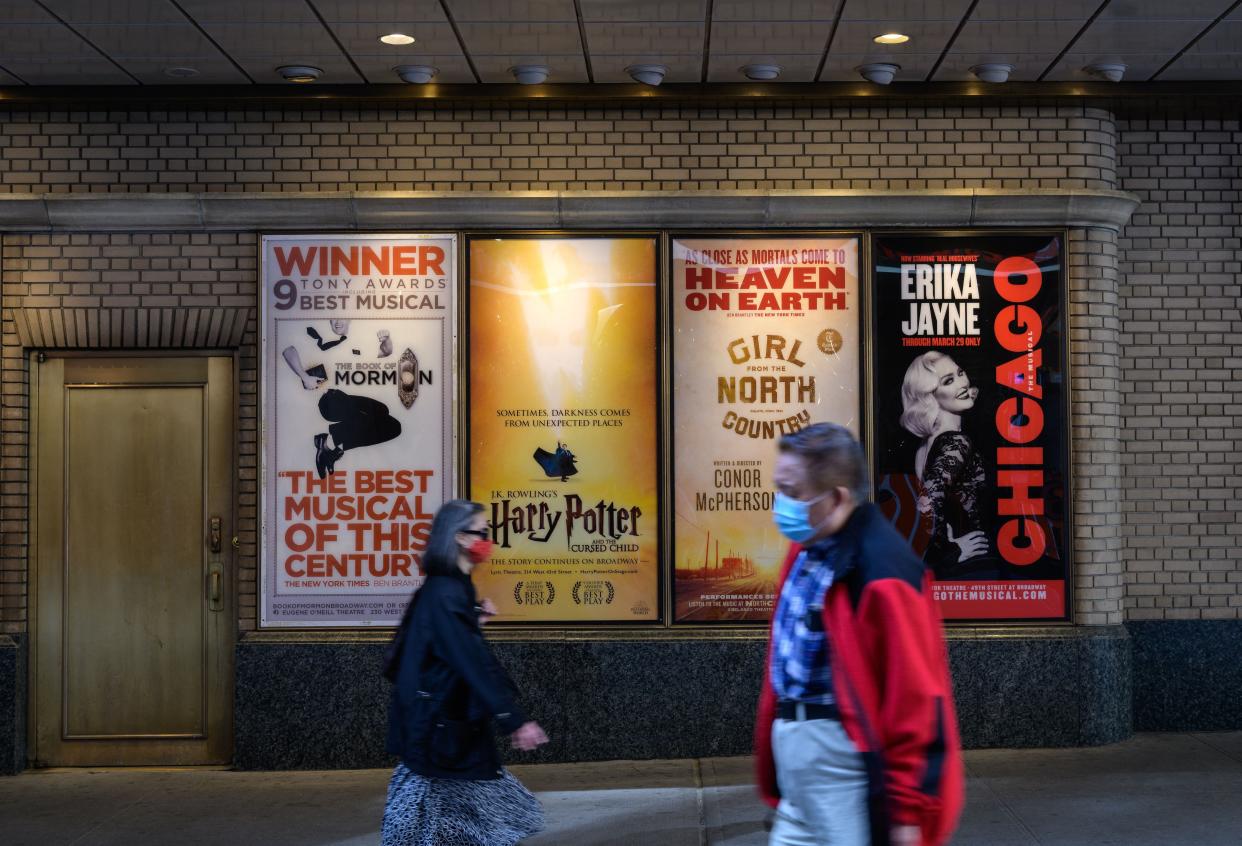 People walk past a closed Broadway theater on May 6, 2021 in New York City.