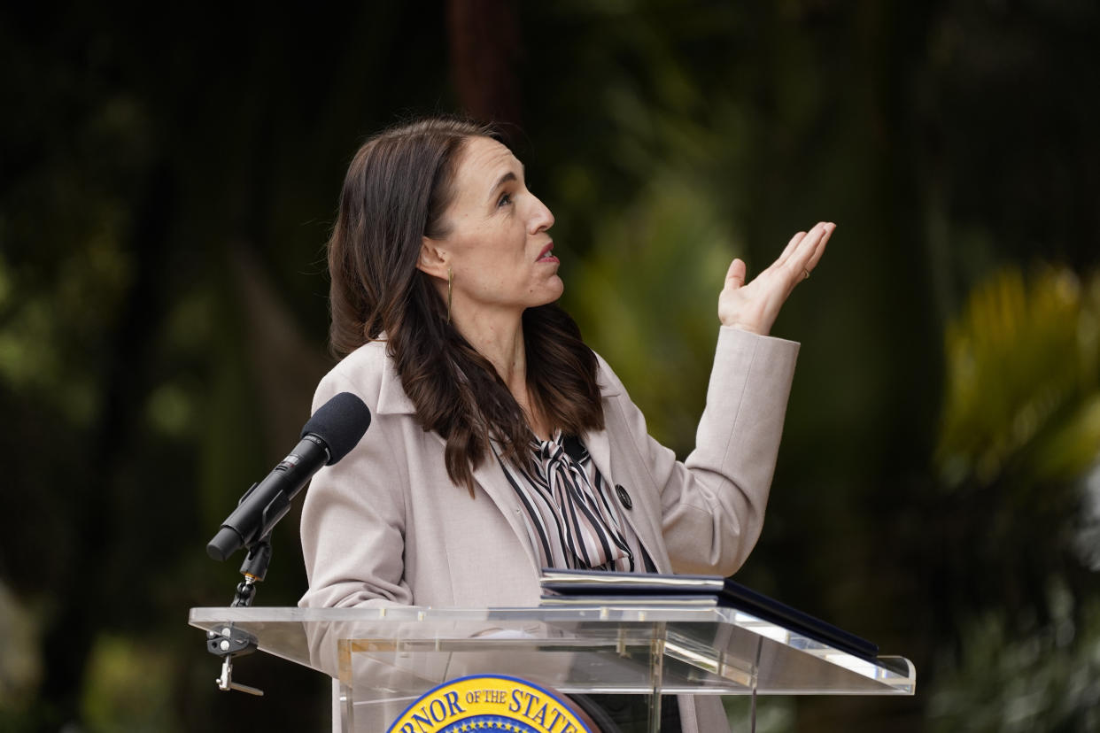 New Zealand Prime Minister Jacinda Ardern gestures toward a tree behind her while speaking at the San Francisco Botanical Garden in San Francisco, Friday, May 27, 2022. Gov. Newsom met with Ardern in Golden Gate Park "to establish a new international partnership tackling climate change." (AP Photo/Eric Risberg)