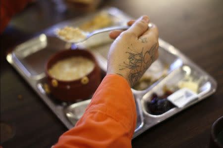 A prison inmate eats breakfast at Oak Glen Conservation Fire Camp #35 in Yucaipa, California November 6, 2014. REUTERS/Lucy Nicholson