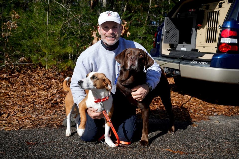 Matthew Zarrella, the retired Rhode Island State Police sergeant who founded the department's K9 search and rescue program in the 1990s, with adopted dogs Toby, right, and Rosie.