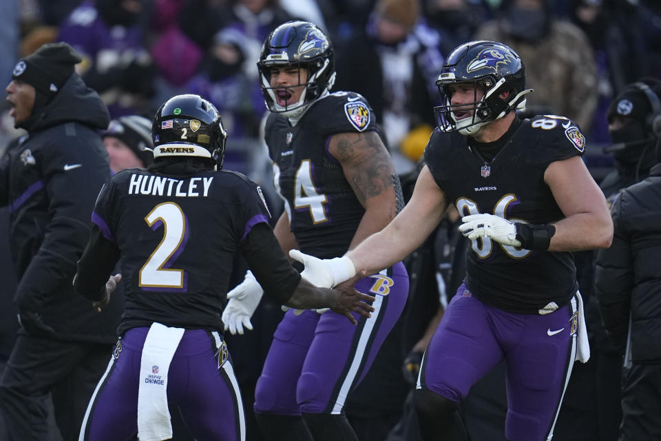 Baltimore Ravens quarterback Tyler Huntley (2) celebrates his touchdown pass with tight end Josh Oliver and tight end Nick Boyle (86) during the first half of an NFL football game, Saturday, Dec. 24, 2022, in Baltimore. (AP Photo/Julio Cortez)