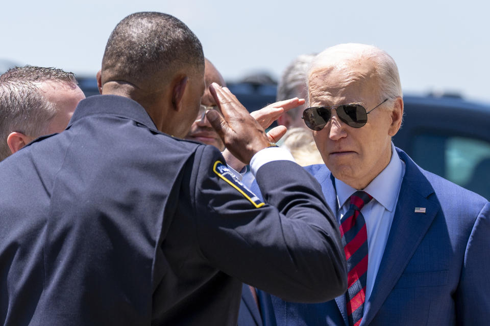 President Joe Biden salutes Charlotte-Mecklenburg Police Department Chief Johnny Jennings, as he arrives on Air Force One at Charlotte Douglas International Airport, Thursday, May 2, 2024, in Charlotte, N.C. Biden is meeting with the families of law enforcement officers shot to death on the job. (AP Photo/Alex Brandon)