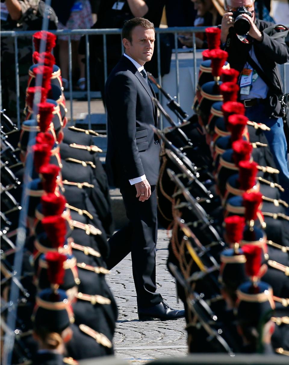 <p>French President Emmanuel Macron reviews an honor guard prior to the traditional Bastille Day military parade on the Champs Elysees, in Paris, Friday, July 14, 2017. (Photo: Kamil Zihnioglu/AP) </p>