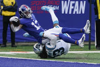 New York Giants' Dante Pettis (13) is tackled by Carolina Panthers' Stantley Thomas-Oliver (23) as he reaches the end zone for a touchdown during the second half of an NFL football game Sunday, Oct. 24, 2021, in East Rutherford, N.J. (AP Photo/Seth Wenig)