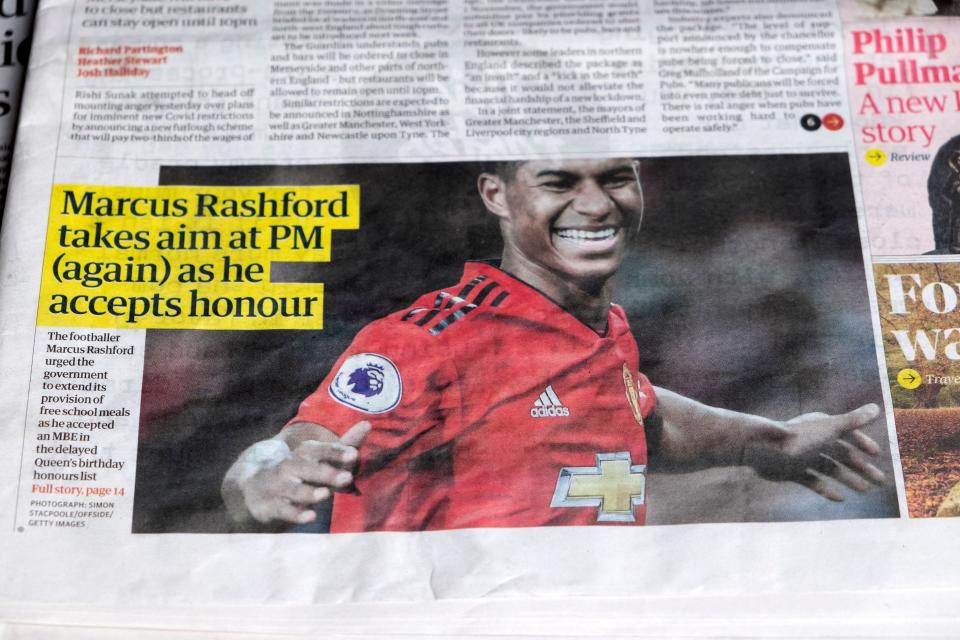 Footballer Marcus Rashford MBE honours Guardian newspaper headlines headline articles school meals campaign on 10 October 2020 England UK.