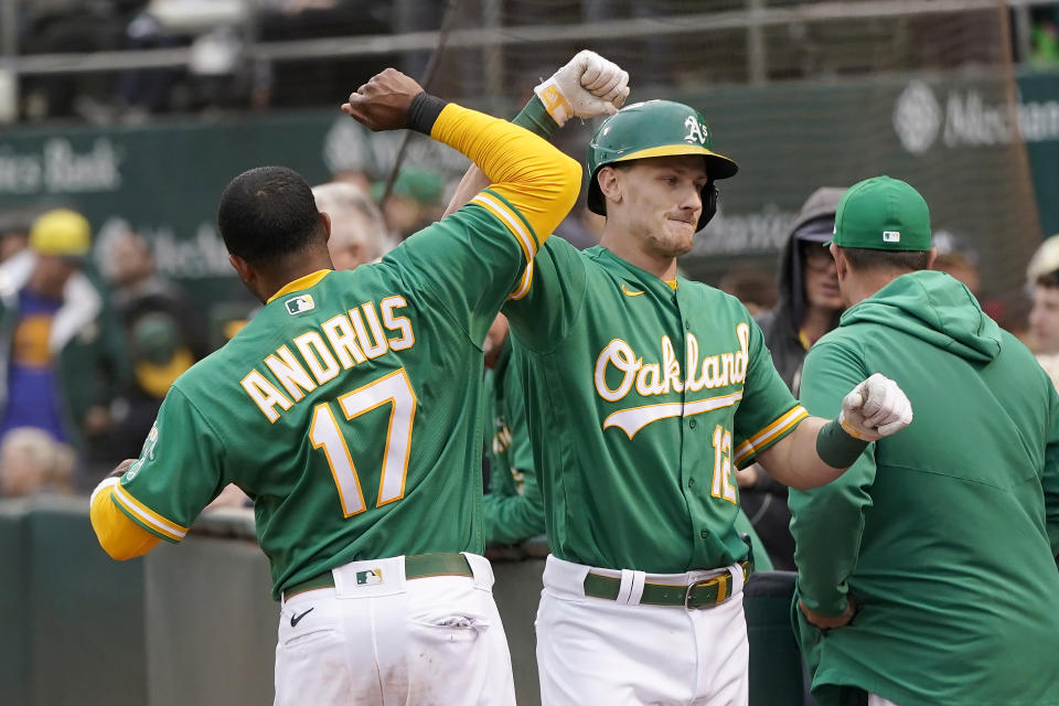 Oakland Athletics' Sean Murphy, right, is congratulated by Elvis Andrus (17) after hitting a home run against the Texas Rangers during the third inning of a baseball game in Oakland, Calif., Friday, May 27, 2022. (AP Photo/Jeff Chiu)