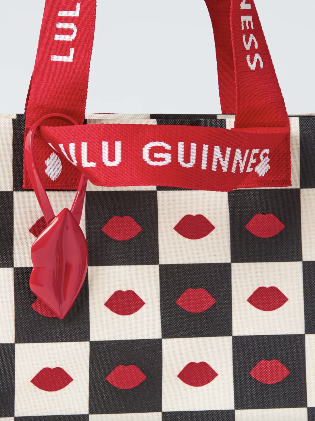 It comes complete with thick straps, a chess board print adorned with the iconic Lulul Guinness lips and even a bold red lipstick tag. (Lulu Guinness / Waitrose)