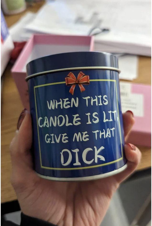 The tin holding the candle reads "when this candle is lit, give me that dick"