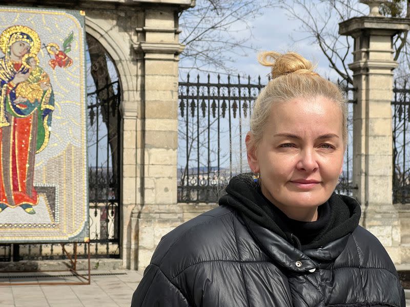 Ukrainian refugee Luidmyla Nazarova waits for humanitarian aid to depart St. George's Cathedral, in Lviv