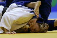 United States' Kayla Harrison fights with Cuba's Yelennis Castillo, dressing a blue kimono, in their women's -78kg category semifinal match during the World Cup of Judo in Sao Paulo, Sunday, May 30, 2010. (AP Photo/Nelson Antoine)