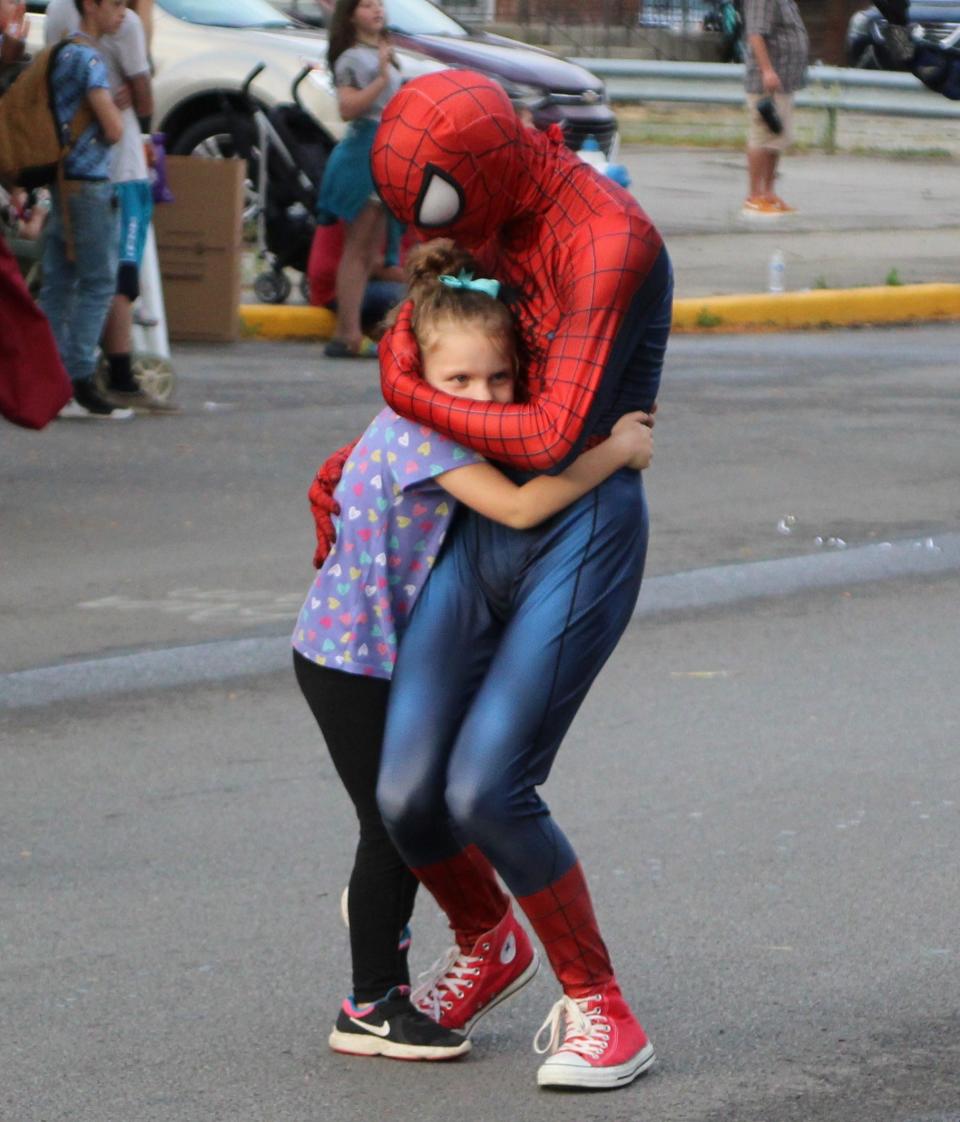 This young girl just wanted a hug from a Spider-Man cosplayer during the 42nd Marion Popcorn Festival Parade held Thursday, Sept. 7, 2023, along East Center Street in Marion. The cosplayers were representing ThunderFury Comics located at the Marion Centre mall.