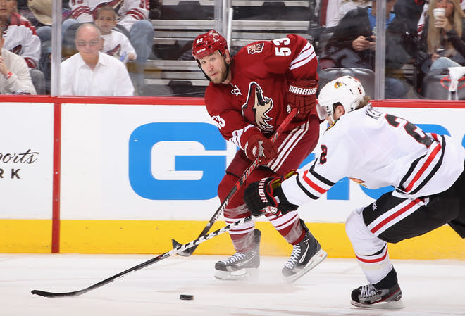 GLENDALE, AZ - APRIL 14: Derek Morris #53 of the Phoenix Coyotes centers the puck past Duncan Keith #2 of the Chicago Blackhawks in the second period of Game Two of the Western Conference Quarterfinals during the 2012 NHL Stanley Cup Playoffs at Jobing.com Arena on April 14, 2012 in Glendale, Arizona. (Photo by Christian Petersen/Getty Images)