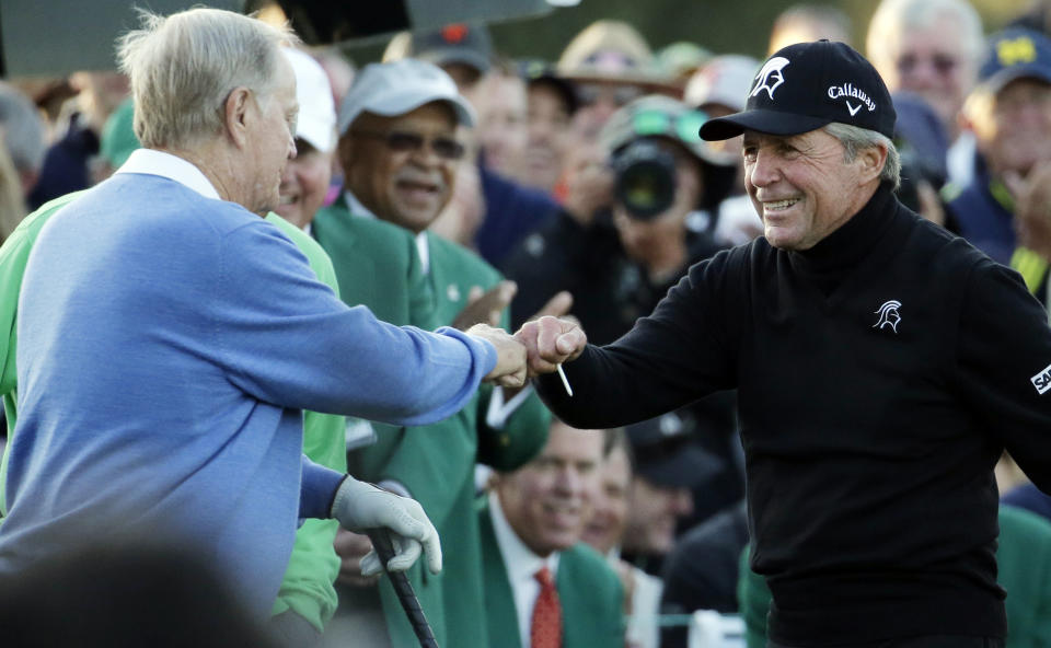 Gary Player, right, touches fists with Jack Nicklaus after hitting a ceremonial drive on the first tee during the first round of the Masters golf tournament Thursday, April 10, 2014, in Augusta, Ga. (AP Photo/Charlie Riedel)