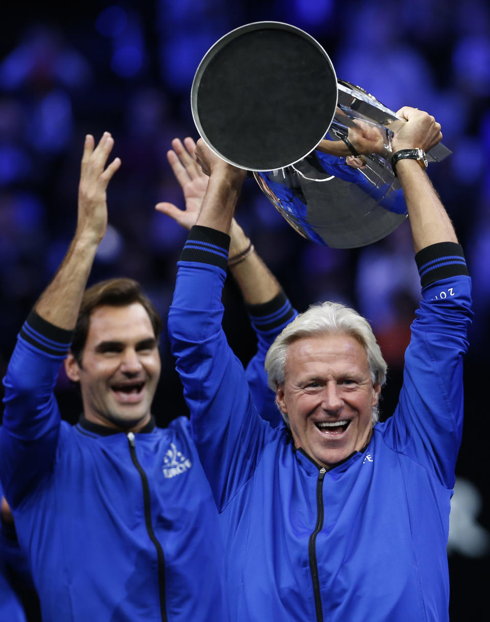 Team Europe's Bjorn Borg, right, and Roger Federer celebrate with the Laver Cup after defeating Team World, Sunday, Sept. 23, 2018, in Chicago. (AP Photo/Jim Young)