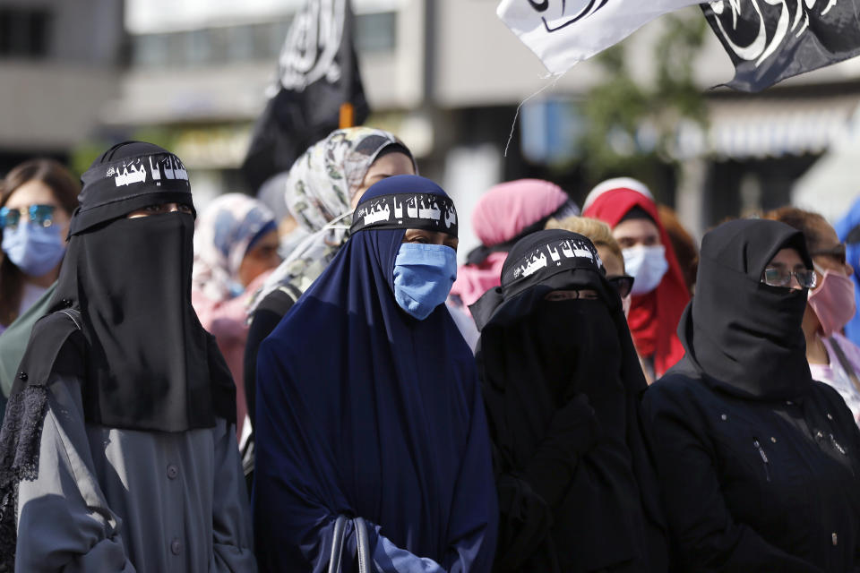 Protesters wear headbands with Arabic that read: "We are your soldiers, Oh Muhammad," during a protest against French President Macron's comments over Prophet Muhammad caricatures, near the Pine Palace, which is the residence of the French ambassador, in Beirut, Lebanon, Friday, Oct. 30, 2020. Thousands of Muslims, from Pakistan to Lebanon to the Palestinian territories, poured out of prayer services to join anti-France protests on Friday, as the French president's vow to protect the right to caricature the Prophet Muhammad continues to roil the Muslim world. (AP Photo/Bilal Hussein)