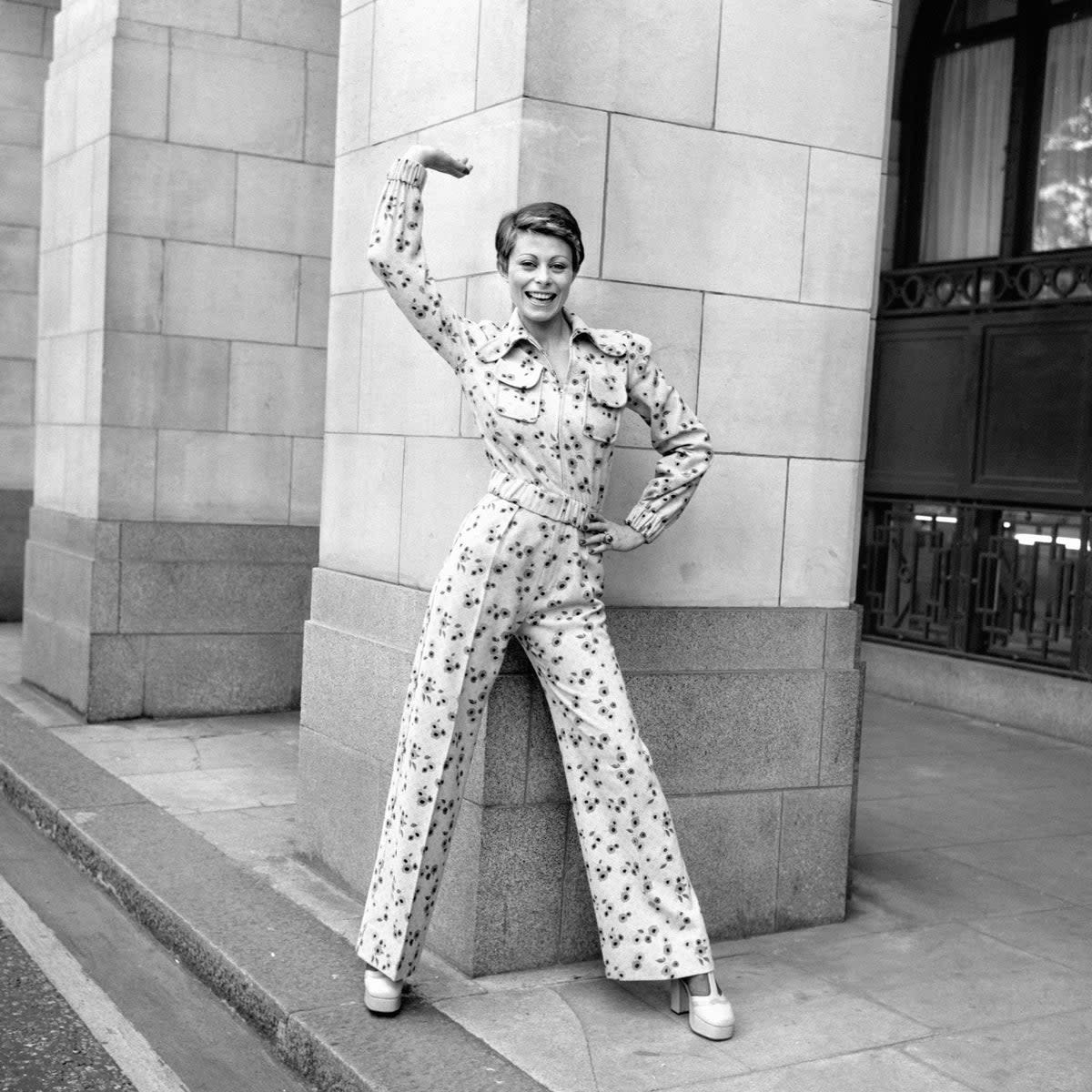 Actor Anne Goddet wears Mary Quant’s ‘Smiler Sam’ trouser suit, in printed pink and yellow flannel (PA)