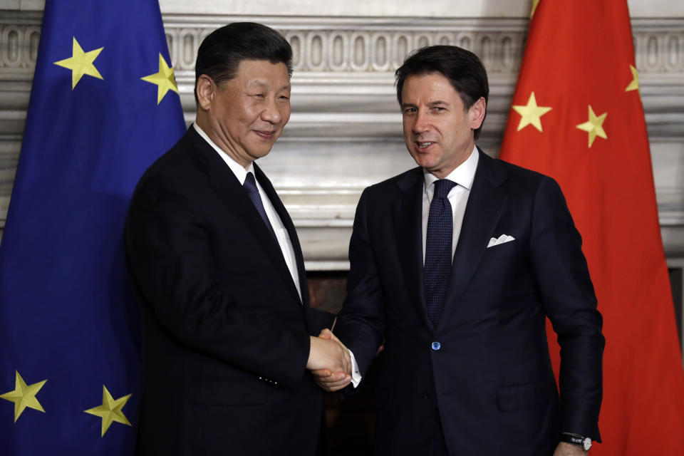 Chinese President Xi Jinping, left, and Italian Premier Giuseppe Conte shake their hands at the end of the signing ceremony of a memorandum of understanding at Rome's Villa Madama, Saturday, March 23, 2019. Italy signed a memorandum of understanding with China on Saturday in support of Beijing's "Belt and Road" initiative, which aims to weave a network of ports, bridges and power plants linking China with Africa, Europe and beyond. (AP Photo/Andrew Medichini)