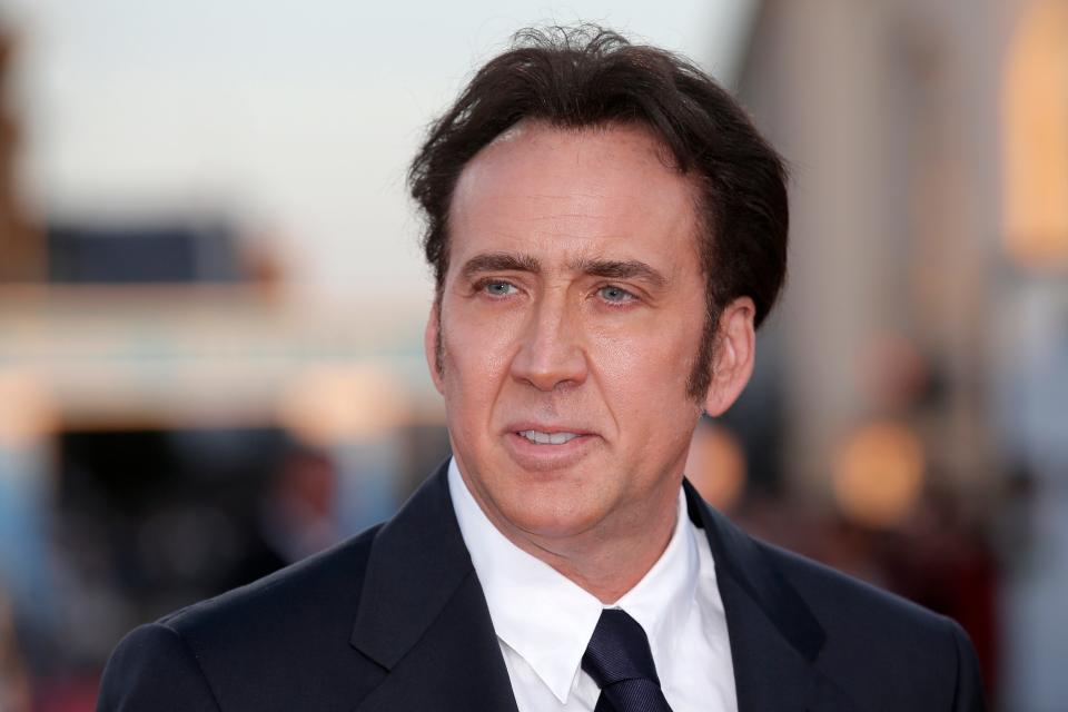 Nicolas Cage gave Jim Carrey a rave review of the book "Memoirs and Misinformation," which portrays the "National Treasure" star with an affinity for semi-naked jiujitsu and prophetic visions of saber-toothed tigers.