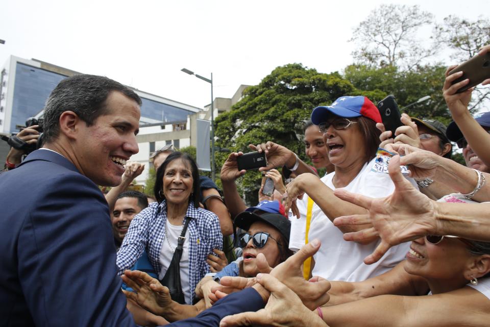 Opposition leader and self-proclaimed interim president of Venezuela Juan Guaido greets supporters at the end of a rally in Caracas, Venezuela, Tuesday, July 23, 2019. The National Assembly approved on Tuesday the return of Venezuela to the Inter-American Treaty of Reciprocal Assistance to strengthen cooperation with the countries of the region and raise pressure on President Nicolas Maduro. (AP Photo/Ariana Cubillos)