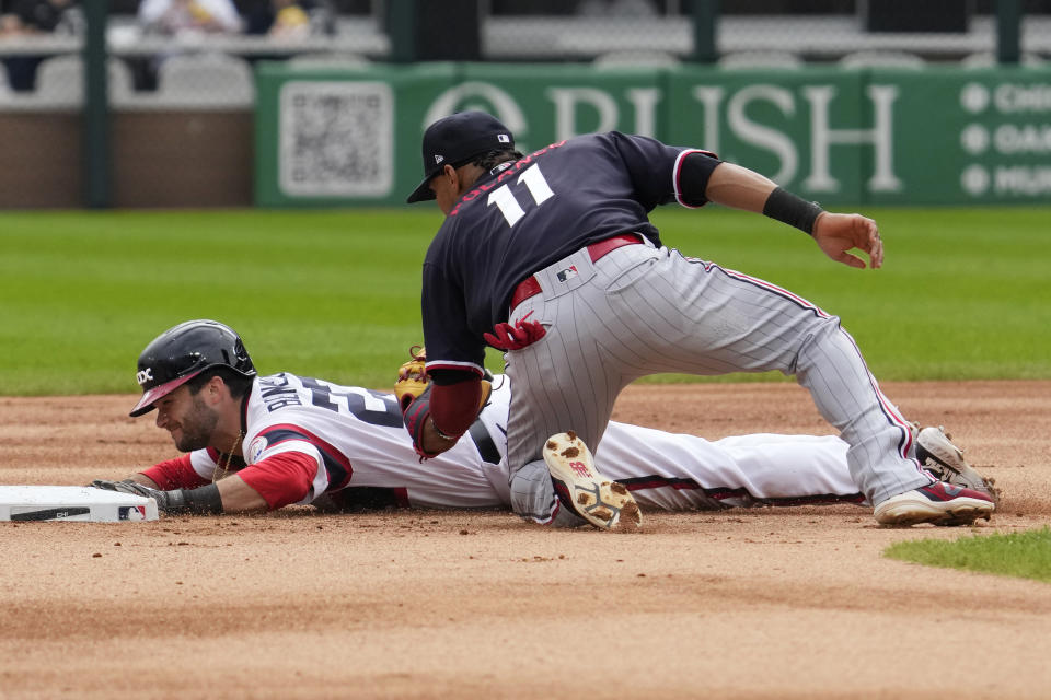 Chicago White Sox's Andrew Benintendi, left, is tagged out by Minnesota Twins second baseman Jorge Polanco during the first inning of a baseball game in Chicago, Sunday, Sept. 17, 2023. (AP Photo/Nam Y. Huh)