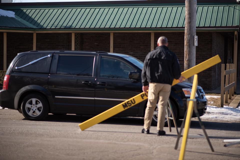 A hearse leaves the area of South Clippert Street and Kalamazoo Avenue Friday afternoon, Jan. 21, 2022, with a body they pulled from the Red Cedar River around 12:30 PM. MSU Police say the body is believed to be that of GVSU student Brendan Santo, missing since October 29th.