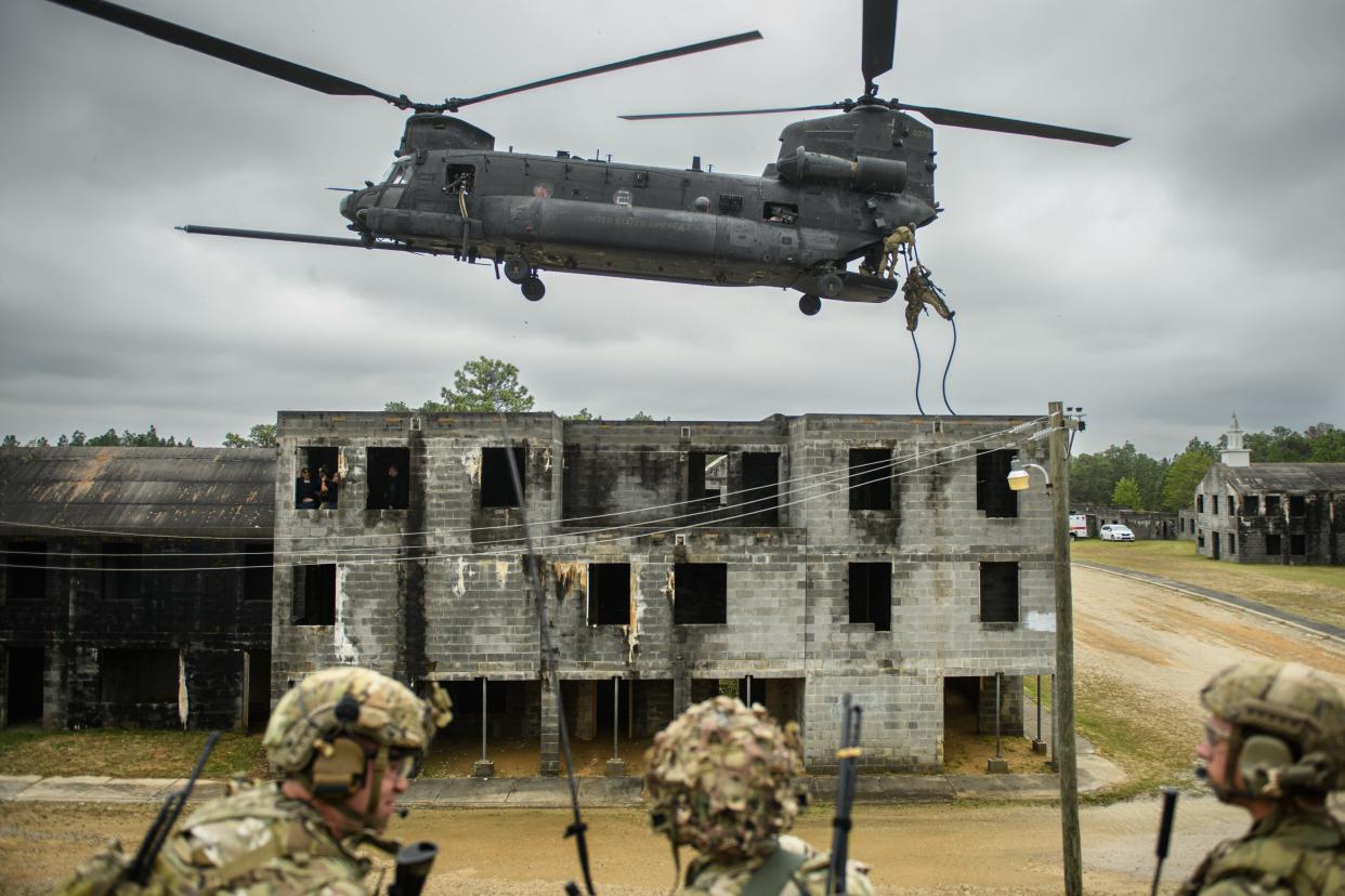 Soldiers part of a 75th Ranger Regiment platoon rappel down ropes suspended from a MH-47 Chinook flown by the 160th Special Operations Aviation Regiment during U.S. Army Special Operations Command's annual capabilities exercise  April 28, 2023, at Fort Liberty.