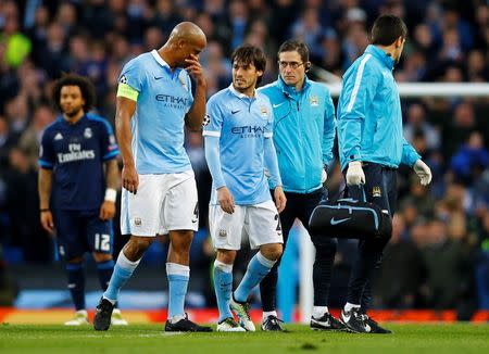 Football Soccer - Manchester City v Real Madrid - UEFA Champions League Semi Final First Leg - Etihad Stadium, Manchester, England - 26/4/16 Manchester City's David Silva walks off to be substituted after sustaining an injury as Vincent Kompany looks on Reuters / Darren Staples