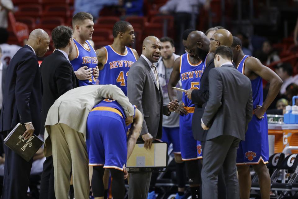 New York Knicks head coach Derek Fisher, center, talks to players during the second half of an NBA basketball game against the Miami Heat, Monday, Feb. 9, 2015, in Miami. The Heat defeated the Knicks 109-95. (AP Photo/Wilfredo Lee),