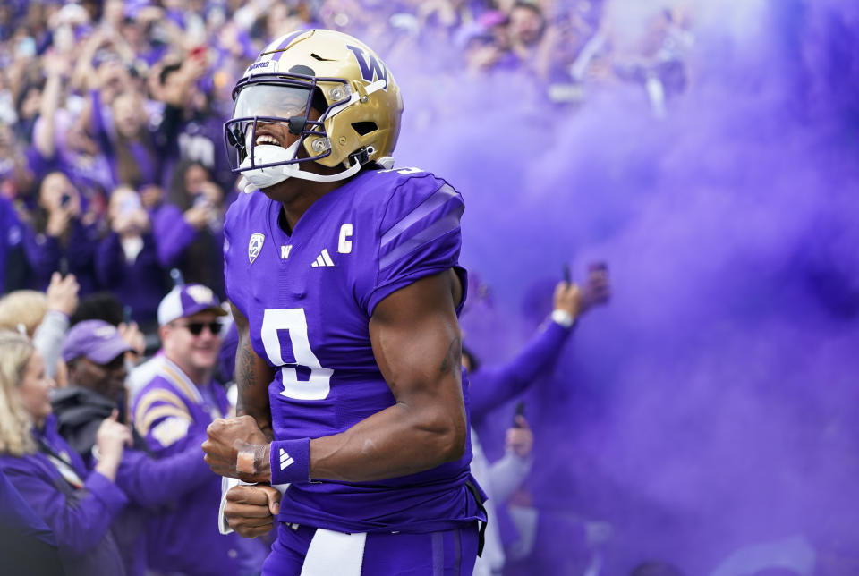 Washington quarterback Michael Penix Jr. yells as he runs out during introductions before an NCAA college football game against Oregon, Saturday, Oct. 14, 2023, in Seattle. (AP Photo/Lindsey Wasson)