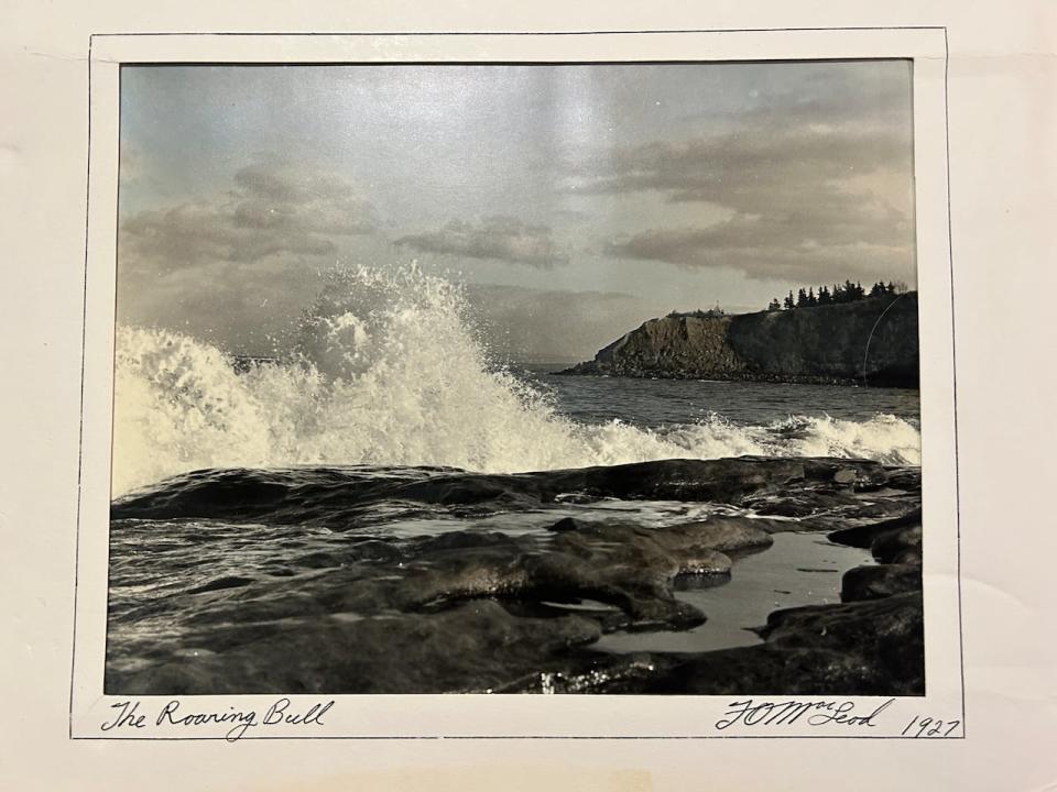 An old photograph called The Roaring Bull by F.O. MacLeod shows waves crashing against the coast.