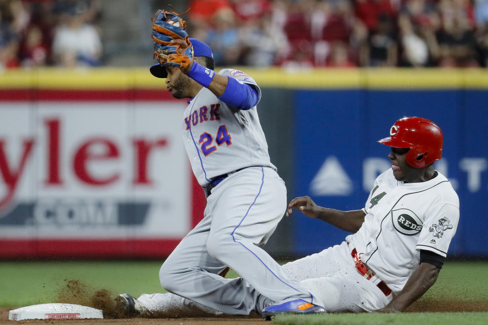 Cincinnati Reds' Aristides Aquino, right, steals second against New York Mets second baseman Robinson Cano (24) in the fourth inning of a baseball game, Friday, Sept. 20, 2019, in Cincinnati. (AP Photo/John Minchillo)