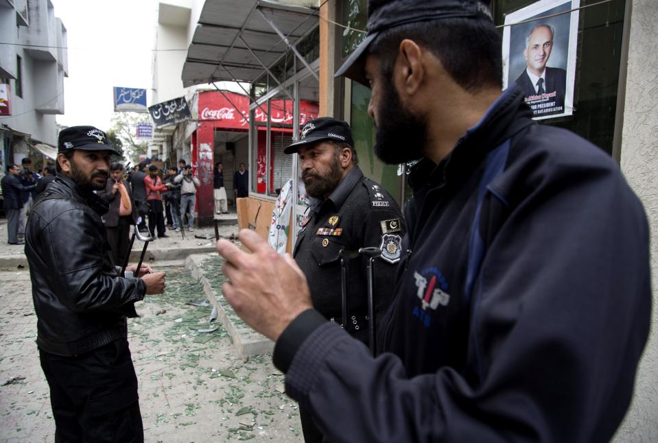 Pakistani police commandos inspect the site after a suicide attack in a court complex, in Islamabad, Pakistan, Monday, March 3, 2014. Two suicide bombers blew themselves up at a court complex in the Pakistani capital on Monday, killing nearly a dozen and wounding scores in a rare terror attack in the heart of Islamabad, officials said. (AP Photo/B.K. Bangash)