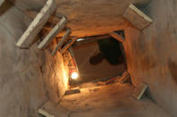 Plywood shoring with a built-in makeshift ladder at the tunnel?s entrance is seen in this drug smuggling tunnel from Mexico that was uncovered by U.S. Border Patrol in Nogales, Arizona, in this photograph released to Reuters on November 22, 2011. REUTERS/U.S. Customs and Border Protection/Handout