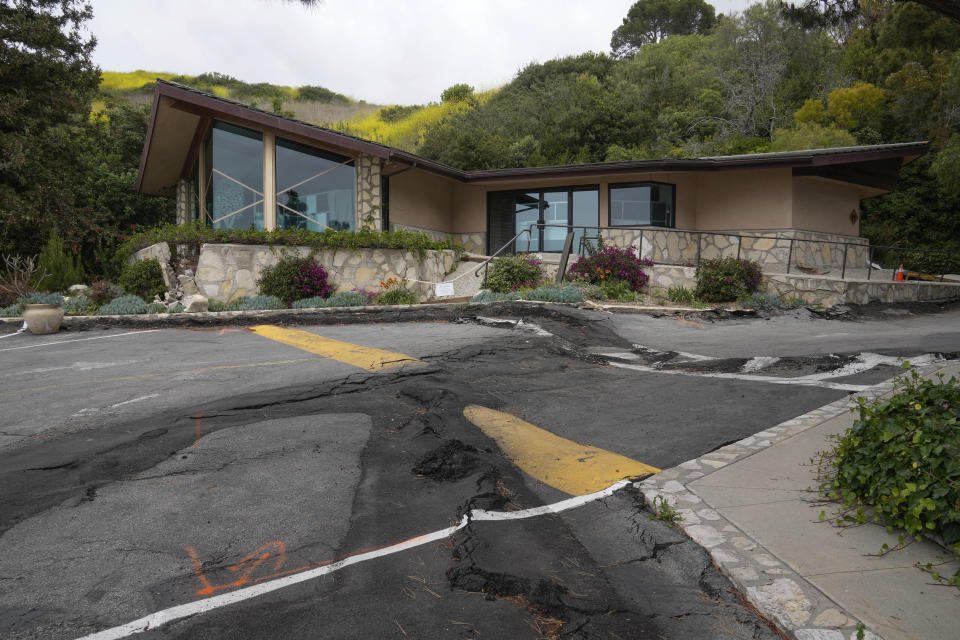 The pavement surface of the parking lot of Wayfarers Chapel shows multiple repairs due to damage from landslides in Rancho Palos Verdes, Calif., Wednesday, May 15, 2024. The modernist chapel features organic architecture with glass walls nestled in a redwood grove overlooking the Pacific Ocean. The Wayfarers Chapel was designed by architect Lloyd Wright, son of Frank Lloyd Wright, and completed in 1951. Wayfarers Chapel management announced plans to move forward with the disassembly of the iconic structure to save it from landslide destruction. (AP Photo/Damian Dovarganes)