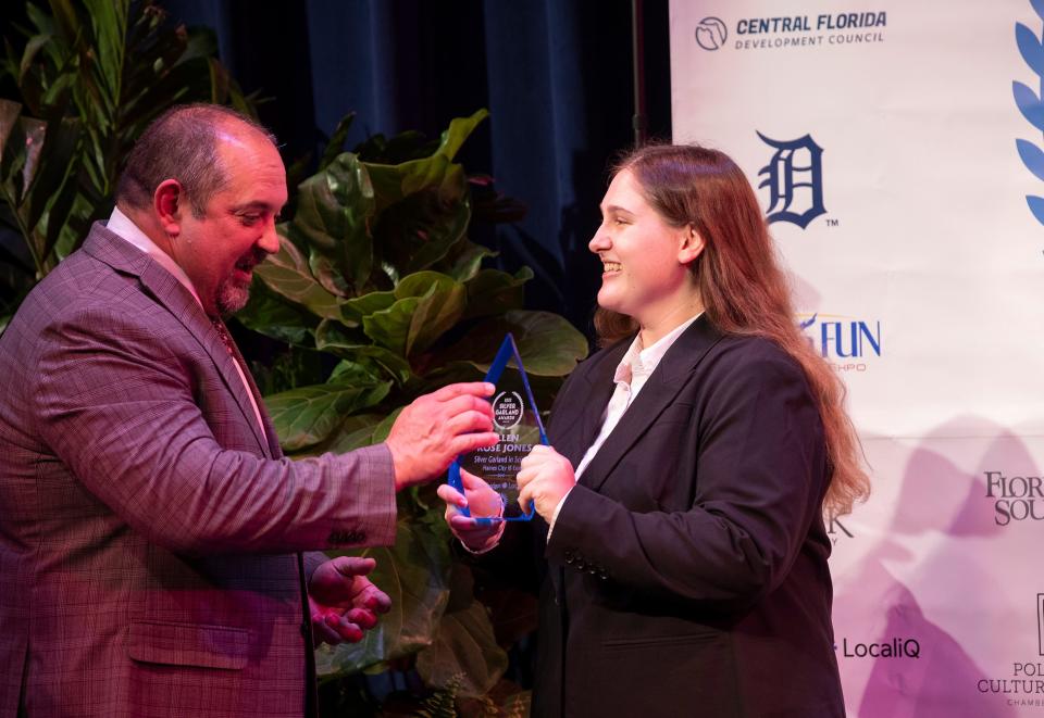 Superintendent of Schools Frederick Heid presents Ellen Rose Jones of Haines City IB High School with the Silver Garland Award for Science.