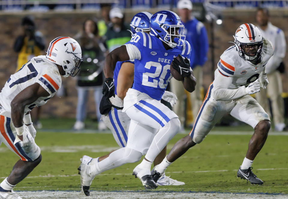 Duke's Jaquez Moore (20) carries the ball for a touchdown past Virginia's Langston Long, left, and Darrius Bratton (8) during the second half of an NCAA college football game in Durham, N.C., Saturday, Oct. 1, 2022. (AP Photo/Ben McKeown)