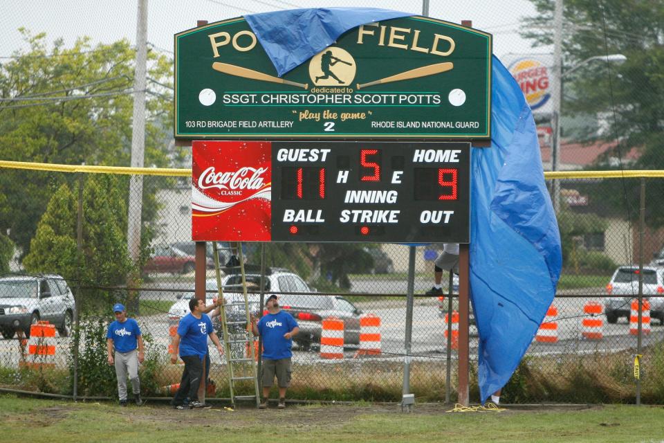 Teammates of Staff Sgt. Christopher Potts unveil the softball field's new sign during a ceremony on July 22, 2006.