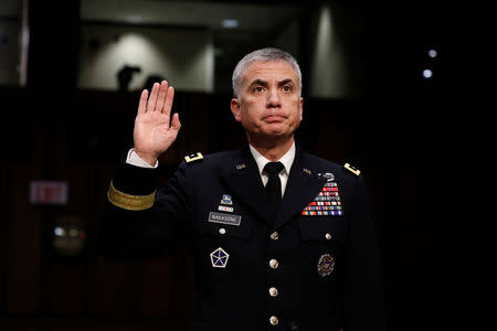 Lieutenant General Paul Nakasone, nominee to lead the National Security Agency and US Cyber Command, is sworn in before the Senate Intelligence Committee on Capitol Hill in Washington, U.S., March 15, 2018. REUTERS/Aaron P. Bernstein