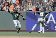 Jul 15, 2018; San Francisco, CA, USA; Oakland Athletics right fielder Stephen Piscotty (25) and center fielder Mark Canha (20) and left fielder Chad Pinder (18) celebrate after the end of the game against the San Francisco Giants at AT&T Park. Mandatory Credit: Neville E. Guard-USA TODAY Sports