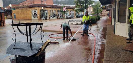 City crews clean sidewalks Tuesday along West Main Street in Downtown Prattville.