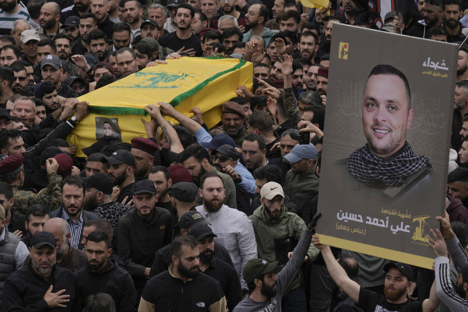 Hezbollah fighters carry the coffin of their comrade, Ali Ahmad Hussein, who was killed by an Israeli strike in south Lebanon, during his funeral procession in the southern Beirut suburb of Dahiyeh, Lebanon, Monday, April 8, 2024. Israel's military says it has killed a commander of Hezbollah's secretive Radwan Force in southern Lebanon. (AP Photo/Bilal Hussein)