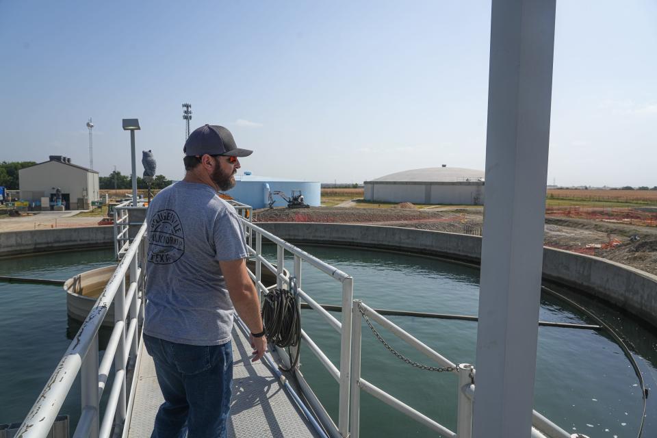 Supervisor Richard Byland walks out over a backwash clarifier at Pflugerville water treatment plant in July.