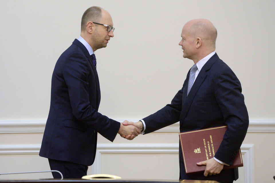 Ukrainian Prime Minister Arseniy Yatsenyuk, left, shakes hands with British Foreign Secretary William Hague in Kiev, Ukraine, Monday, March 3, 2014. Pro-Russian troops took over a ferry terminal on the easternmost tip of Crimea close to Russia on Monday, exacerbating fears that Moscow is planning to bring even more troops into this strategic Black Sea region. (AP Photo/Andrew Kravchenko, Pool)