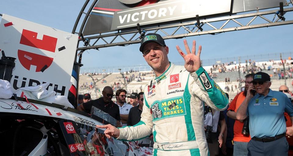 denny hamlin celebrates in dover victory lane