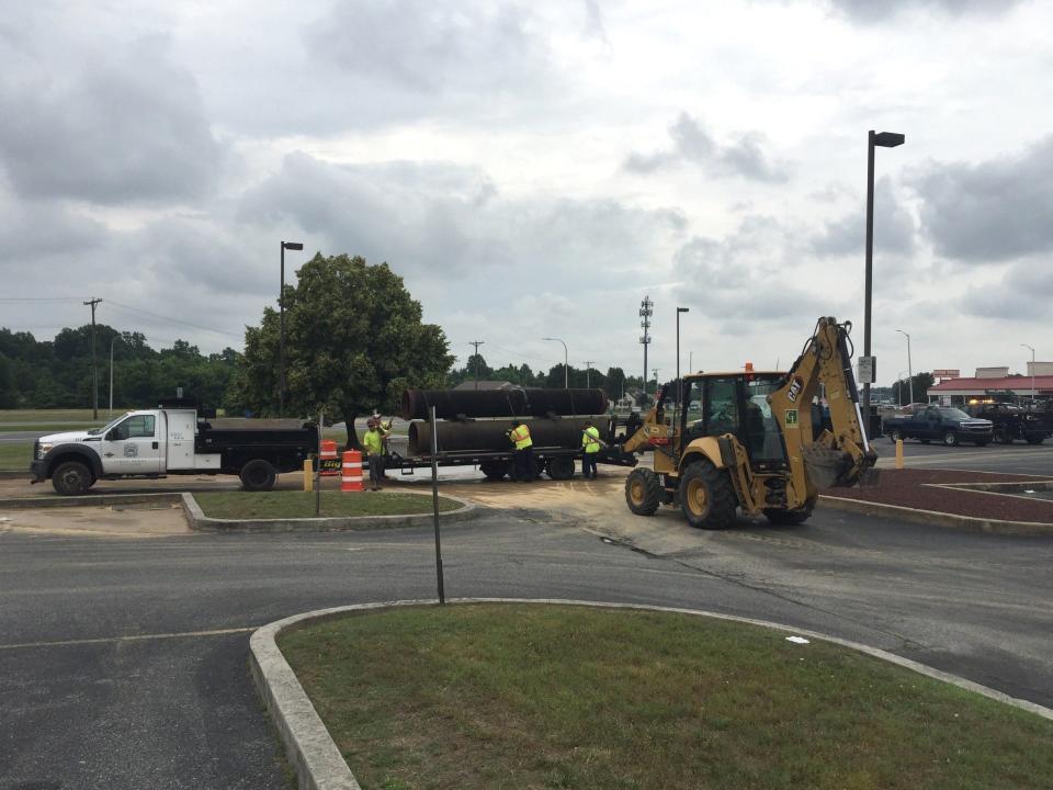 Crews prepare to unload replacement pipes after a sewer force main break in Dover June 4, 2024.