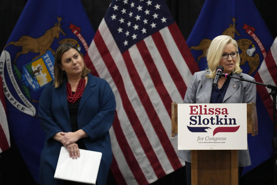 U.S. Rep. Elissa Slotkin, D-Mich., looks towards Rep. Liz Cheney, R-Wyo., as Cheney offers her support during a campaign rally, Tuesday, Nov. 1, 2022, in East Lansing, Mich. Slotkin emphasized how a shared concern for a functioning democracy can unite Democrats and Republicans despite policy disagreements. (AP Photo/Carlos Osorio)