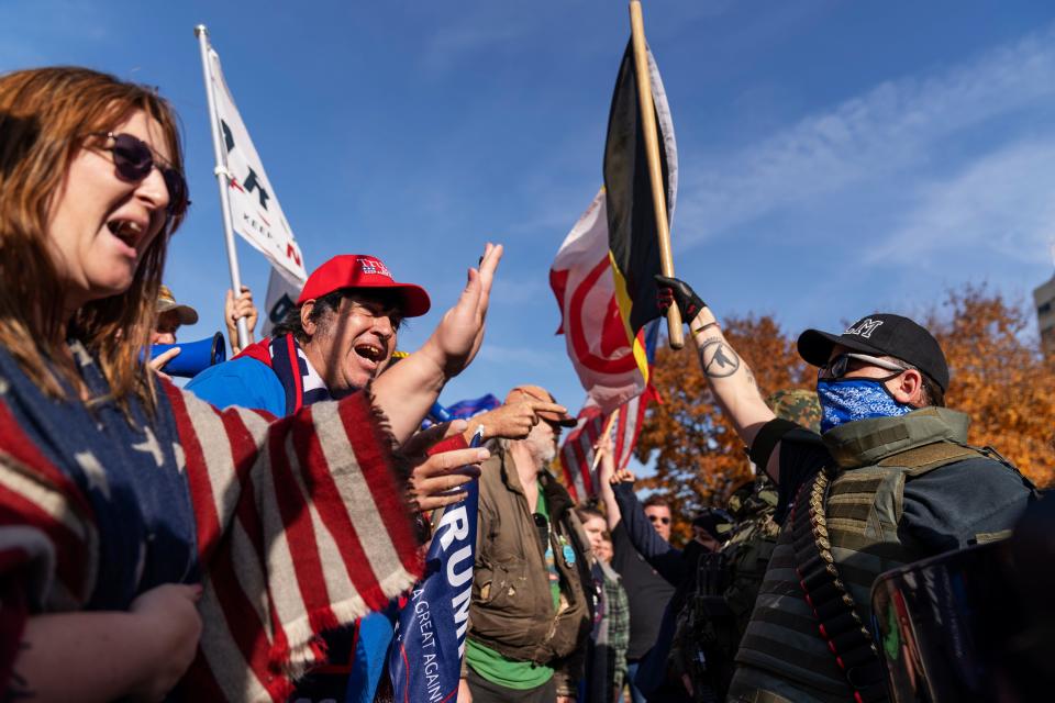 Trump supporters, at left, demonstrating the election results are confronted by counterprotesters at the State Capitol in Lansing, Mich., on Nov. 7, 2020.