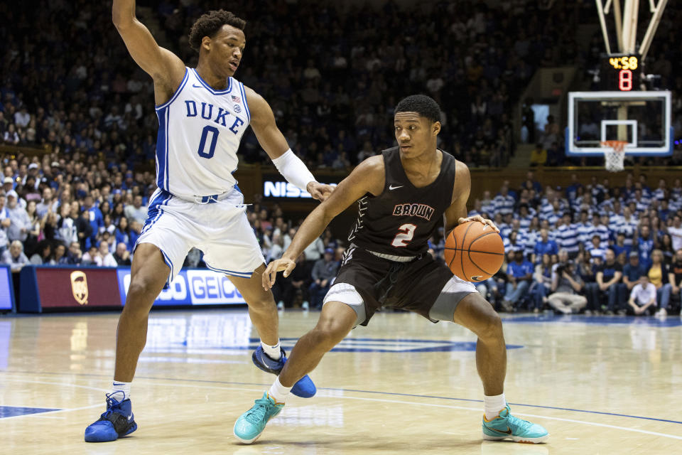 Brown's Brandon Anderson (2) handles the ball as Duke's Wendell Moore Jr. (0) defends during the first half of an NCAA college basketball game in Durham, N.C., ;Saturday, Dec. 28, 2019. (AP Photo/Ben McKeown)