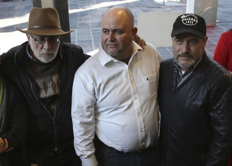 FILE - In this Jan. 9, 2019 file photo, Mexican writer and activist Javier Sicilia, from left, Julian LeBaron and brother Adrian, pose for photos during a press conference in Mexico City. Julian LeBaron, a prominent member of a community of U.S.-Mexican dual citizens living in northern Mexico that was shattered by the November massacre of three women and six children along a rural road has fled to the United States after an apparent threat on his life. (AP Photo/Marco Ugarte, File)