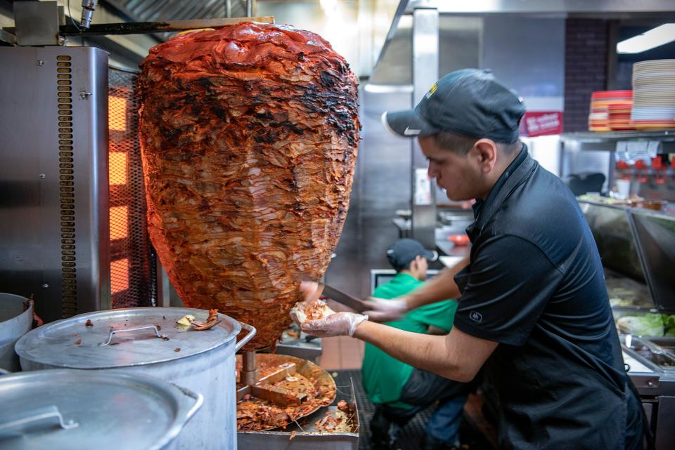 Roasted pork, for tacos al pastor at Los Guachos Taqueria in Columbus, comes directly off the spit. Founded by Mexican immigrants Carlos Nonato and his sister, Edith, Los Guachos has expanded from a food truck to four restaurants in the Columbus area.